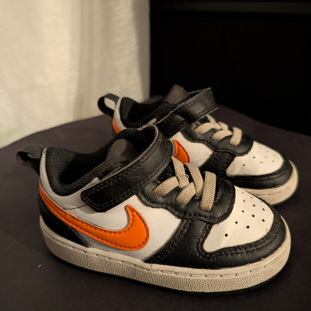 Nike Kids' Black and White Sneakers with Orange Swoosh